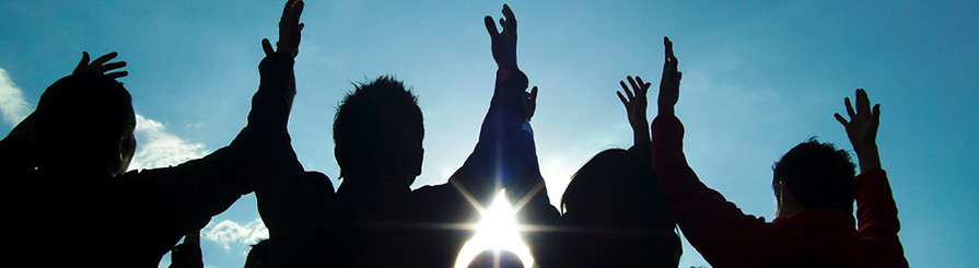 Photo of folks praying outside.