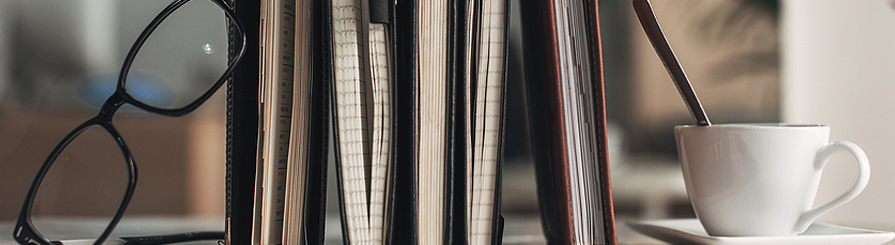 Glasses and books on a shelf.