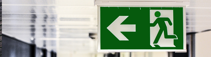 Sign with arrow and running person icon.